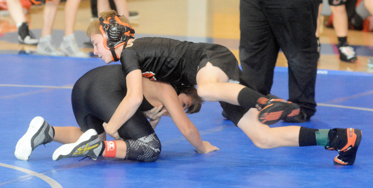 Bo Buddemeyer (green anklet) works towards winning one of his three matches Saturday during the Capital City Middle School Wrestling Tournament held at Capital City High School in Jefferson City.